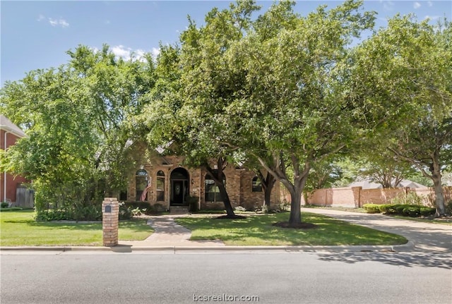 obstructed view of property featuring a front yard