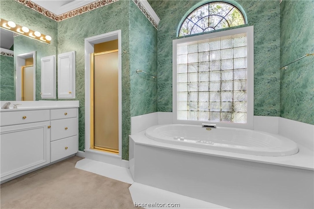 bathroom featuring vanity and independent shower and bath