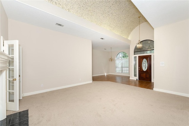 9300 Lakeside Ct, College Station, TX 77845 - foyer featuring carpet flooring, baseboards, lofted ceiling, and a chandelier