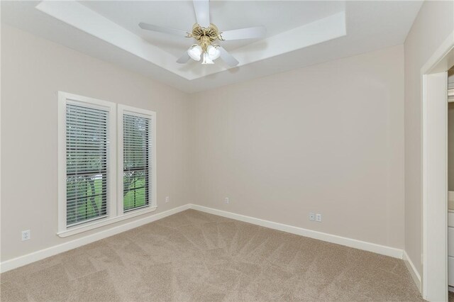 9300 Lakeside Ct, College Station, TX 77845 - carpeted empty room featuring a raised ceiling, baseboards, and a ceiling fan