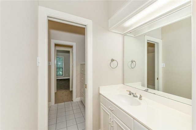 9300 Lakeside Ct, College Station, TX 77845 - bathroom with tile patterned floors, vanity, and baseboards