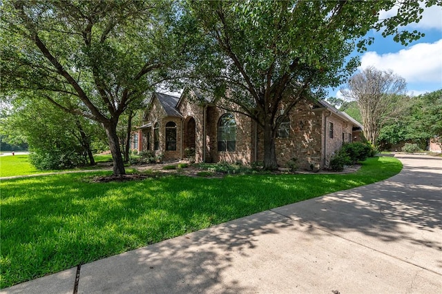 9300 Lakeside Ct, College Station, TX 77845 - tudor-style house featuring brick siding and a front lawn
