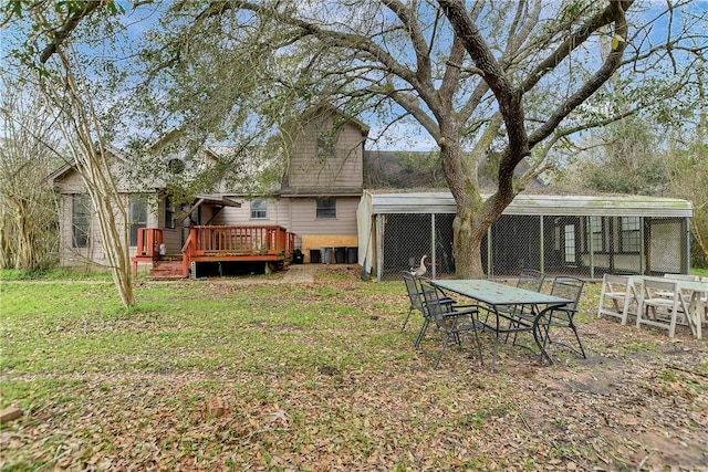 back of property with an outbuilding, a lawn, and a wooden deck