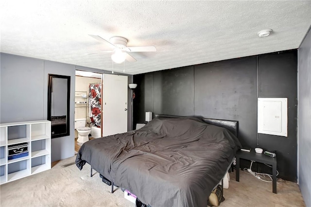 bedroom with electric panel, a ceiling fan, carpet floors, and a textured ceiling