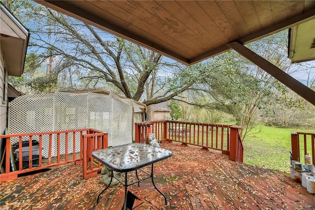 wooden terrace with a lawn