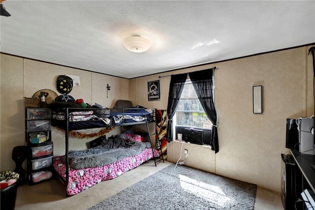 bedroom with crown molding and a textured ceiling