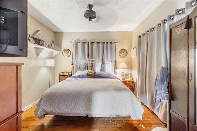 bedroom featuring hardwood / wood-style floors and ceiling fan