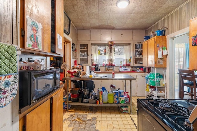 kitchen featuring stove and white cabinetry