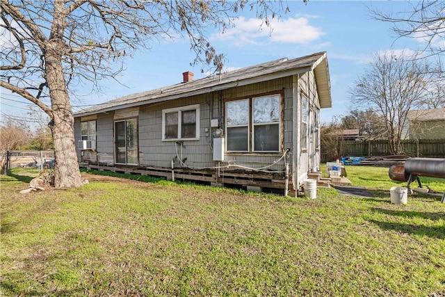 rear view of property with a yard