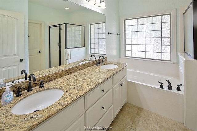 bathroom with tile patterned flooring, vanity, and separate shower and tub