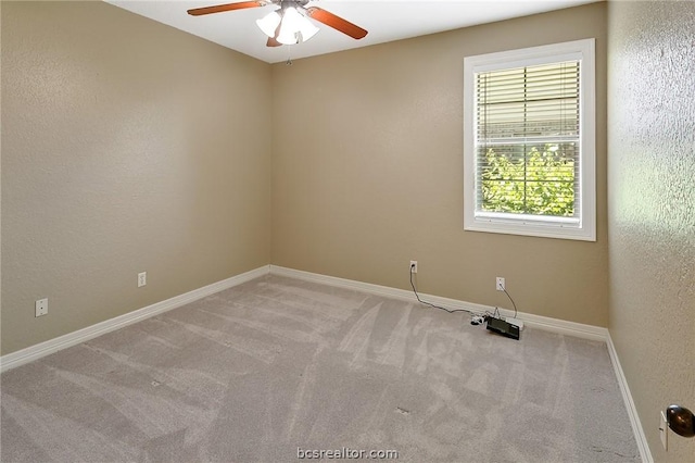 spare room featuring ceiling fan and light carpet