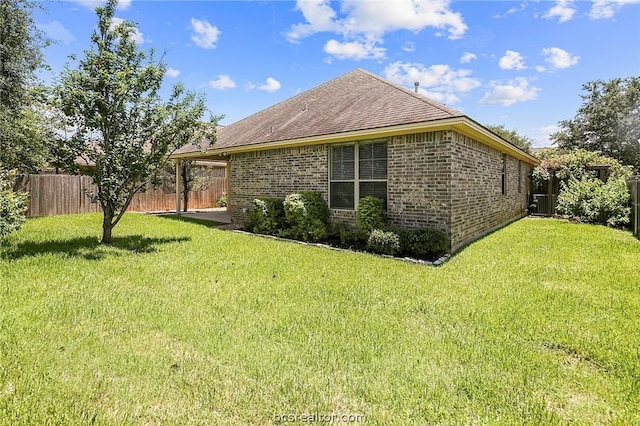 view of side of home with a lawn