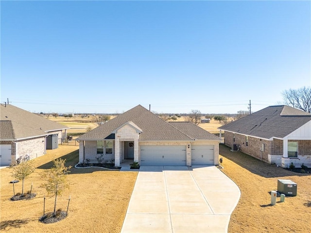 view of front of house featuring a garage and a front yard