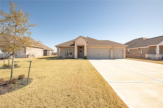 ranch-style house featuring a garage and a front yard