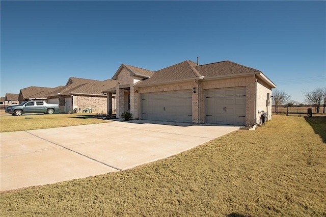 ranch-style home with a garage and a front yard