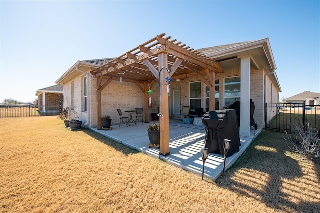 back of property featuring a yard, a patio area, and a pergola