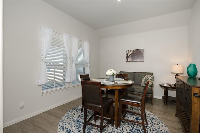 dining room featuring vaulted ceiling and hardwood / wood-style floors