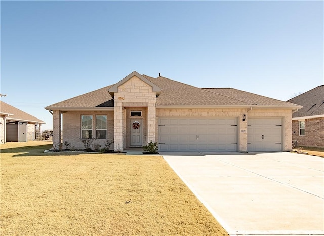 view of front of home with a garage and a front yard