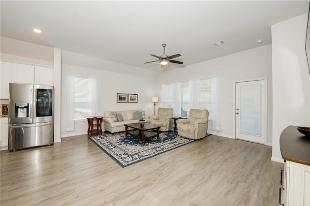 living room with ceiling fan, a healthy amount of sunlight, and light wood-type flooring