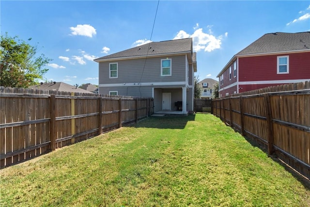 rear view of property with a yard