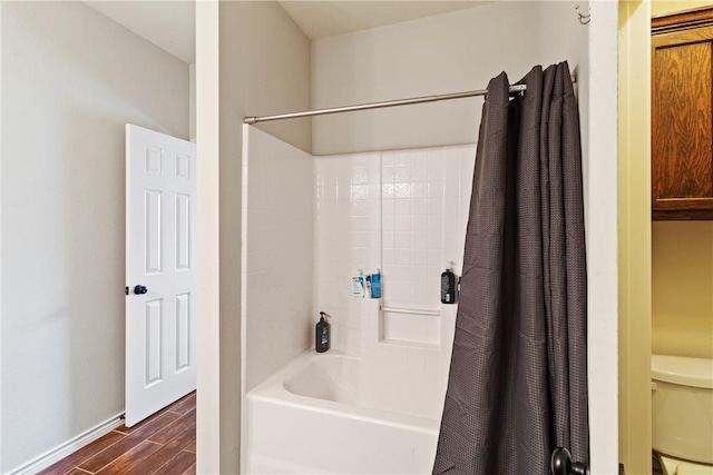 bathroom featuring shower / bath combination with curtain, toilet, and wood-type flooring