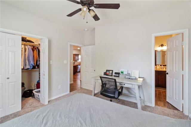 bedroom featuring ceiling fan, light carpet, connected bathroom, and a closet