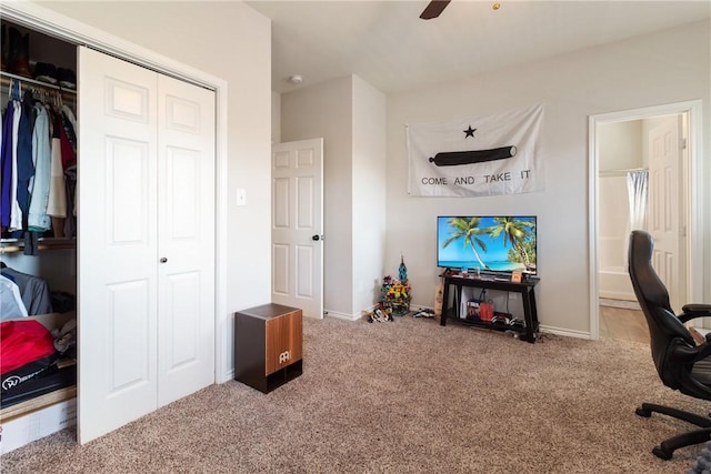 carpeted office space featuring ceiling fan