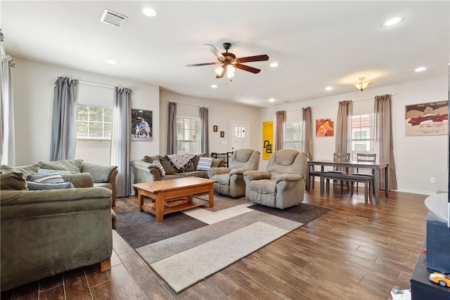 living room with ceiling fan and dark hardwood / wood-style floors