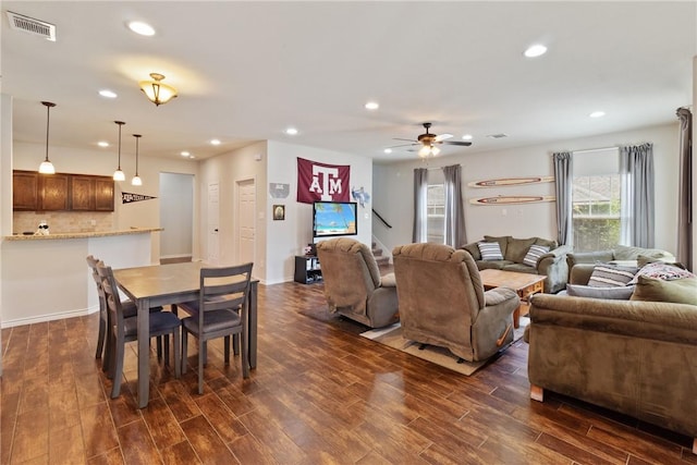 living room with ceiling fan and dark wood-type flooring