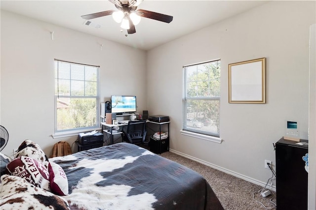 bedroom featuring ceiling fan and carpet