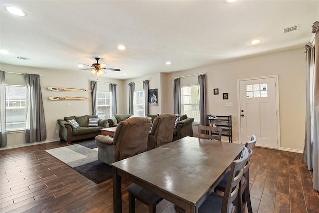 dining space with plenty of natural light, ceiling fan, and dark hardwood / wood-style flooring