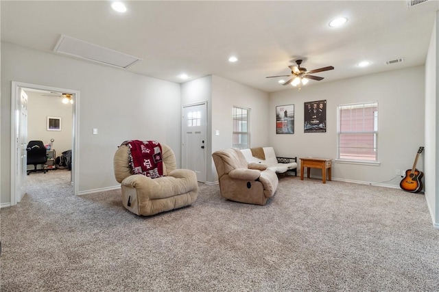 living area with carpet floors and ceiling fan