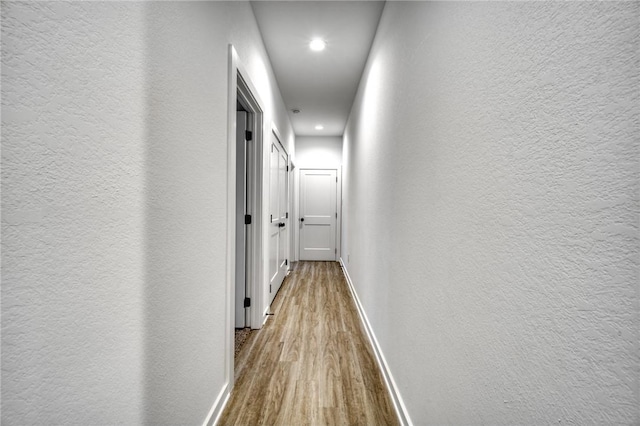 3803 Alamosa St, College Station, TX 77845 - corridor with wood finished floors, a textured wall, baseboards, and recessed lighting