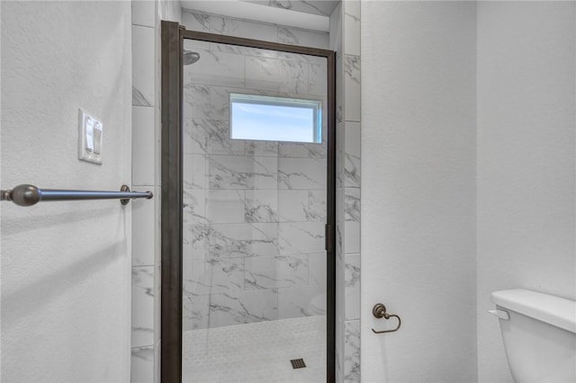 3803 Alamosa St, College Station, TX 77845 - full bathroom featuring toilet, a textured wall, and a marble finish shower