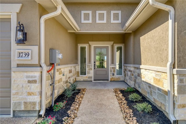3803 Alamosa St, College Station, TX 77845 - doorway to property featuring stucco siding and stone siding