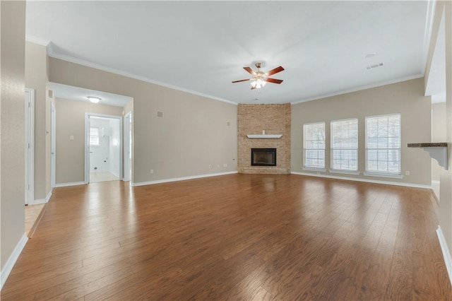 unfurnished living room featuring ceiling fan, crown molding, a fireplace, and light hardwood / wood-style floors