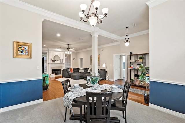 4906 Park Row Pl, Bryan, TX 77802 - dining area with a ceiling fan, a fireplace, wood finished floors, ornate columns, and crown molding