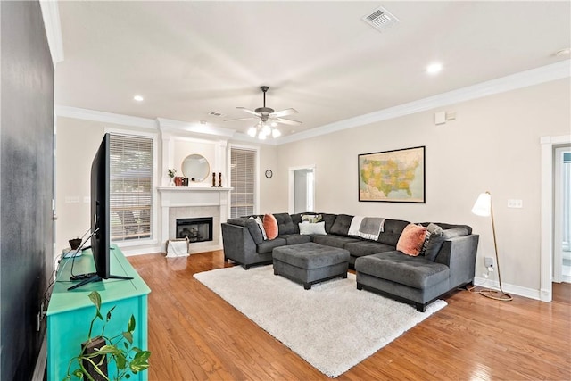 4906 Park Row Pl, Bryan, TX 77802 - living area with light wood-style flooring, crown molding, a ceiling fan, a fireplace, and recessed lighting