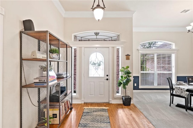4906 Park Row Pl, Bryan, TX 77802 - foyer featuring ornamental molding, healthy amount of natural light, and wood finished floors