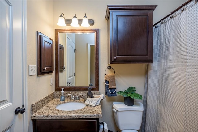 bathroom featuring vanity, toilet, and a shower with curtain