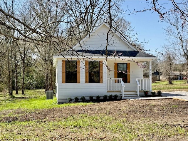 bungalow-style home with covered porch and central AC unit