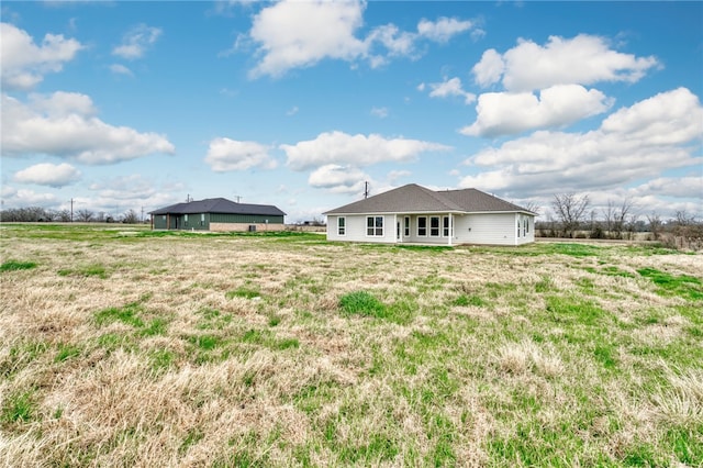 back of property featuring a rural view