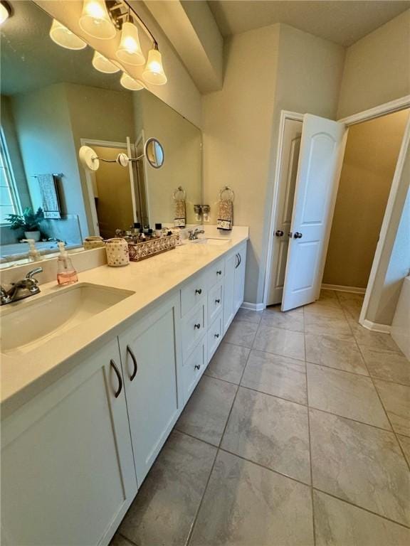 bathroom featuring tile patterned floors, a washtub, and vanity