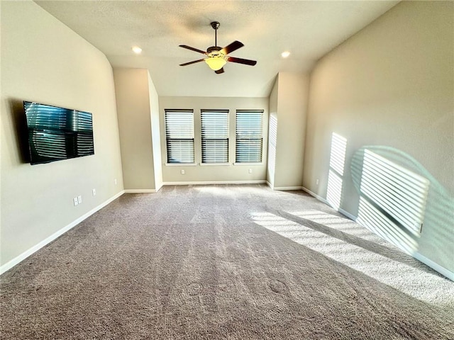 unfurnished living room featuring carpet flooring, a textured ceiling, vaulted ceiling, and ceiling fan