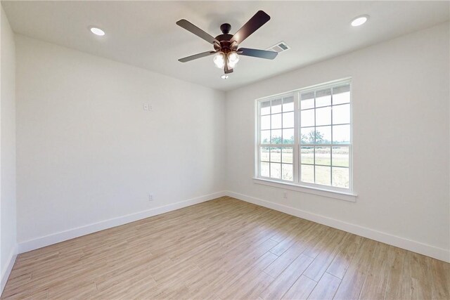 10120 Henley Cv, Iola, TX 77861 - empty room with baseboards, light wood-style flooring, ceiling fan, and recessed lighting