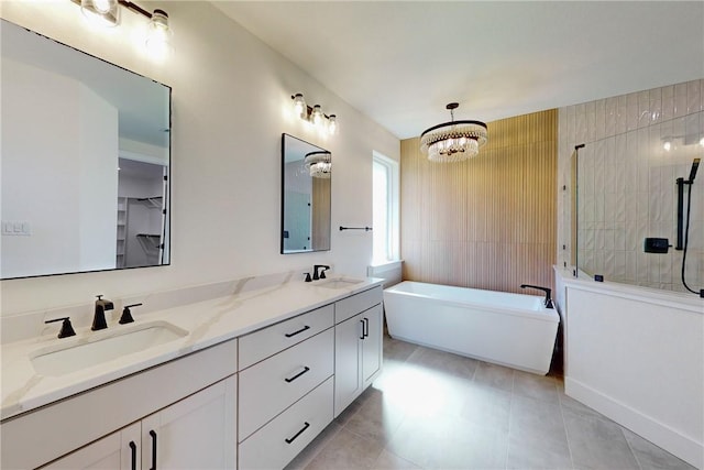 bathroom with a bathtub, vanity, and a chandelier