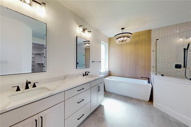 10120 Henley Cv, Iola, TX 77861 - full bath with a freestanding tub, double vanity, a tile shower, a chandelier, and tile patterned flooring