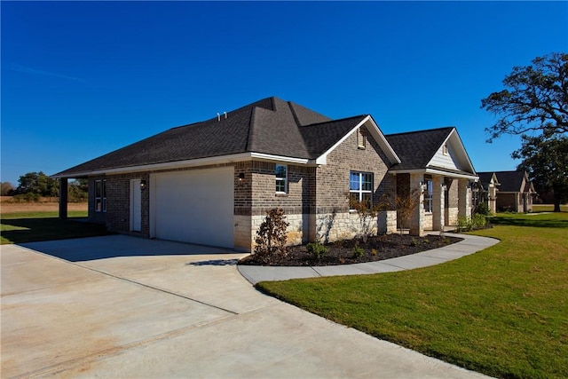 view of front of property with a garage and a front lawn