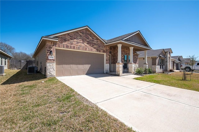 view of front of home featuring brick siding, an attached garage, driveway, and a front yard