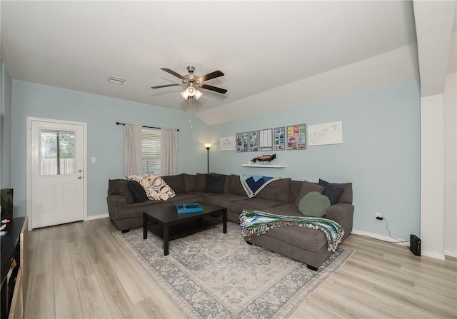 living room with visible vents, baseboards, wood finished floors, and a ceiling fan